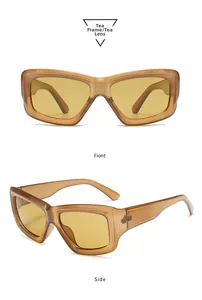 Detail view of tea-colored rectangular sunglasses with thick acetate frames and tinted lenses