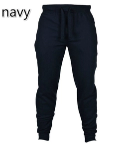 Detail of navy jogger pants featuring elastic drawstring waist and ribbed ankle cuffs