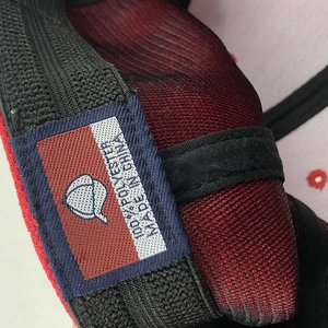 Close-up of baseball cap interior with 100% polyester label and black elastic sweatband
