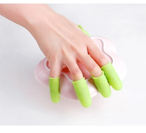 Detail of hand wearing green anti-slip silicone finger protectors for wound care
