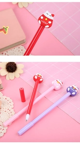 Close-up of cute cartoon lucky cat charm on colorful student gel pens with lucky lettering