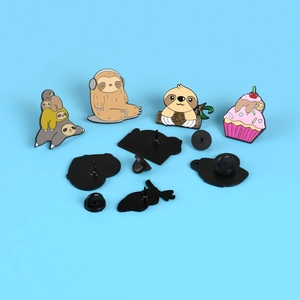 Set of four cute cartoon sloth enamel pins featuring music and cupcake designs