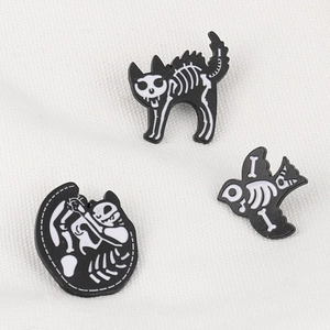 Detailed trio of vintage-style enamel pins featuring black and white skeletal animal motifs