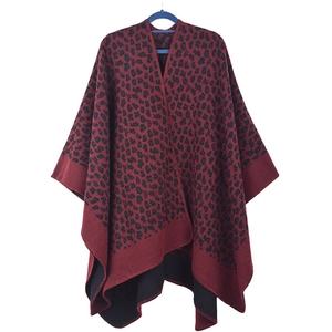 Detail of red and black leopard print knit shawl with an asymmetric open front hem