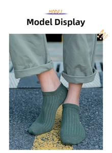Detail of olive green ribbed cotton ankle socks for men with elastic cuff on asphalt
