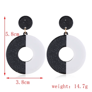 Detail view of black and white geometric acrylic earrings with size and weight specs