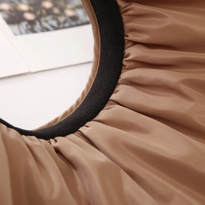 Detail of pleated brown sun visor with black soft velvet lining and dual-layer fabric