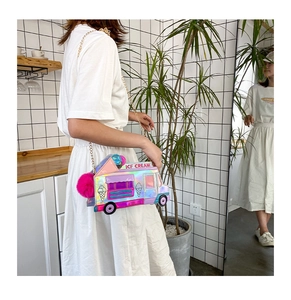 Detail of laser holographic ice cream truck crossbody bag with pink pompom and gold chain