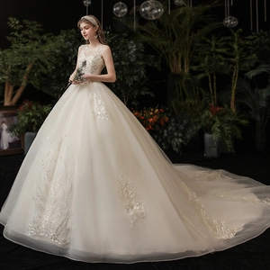 Elegant ivory off-shoulder wedding dress with intricate embroidery and a long train