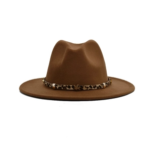 Detail of brown fedora hat featuring a leopard print ribbon and gold star metal ornament