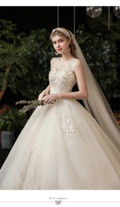 Detail of ivory wedding dress with floral lace embroidery and sequin bodice