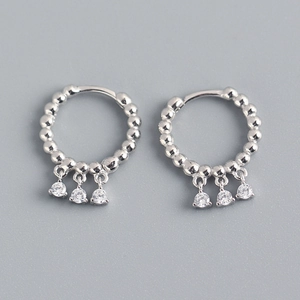 Detail view of S925 sterling silver hoop earrings with three dangling cubic zirconia stones