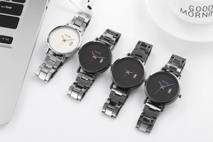 Detail of four YOLAKO quartz watches with calendar window on a modern office desk