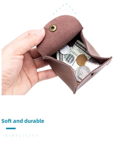 Detailed view of hand-held mini brown genuine leather coin purse with metal snap closure