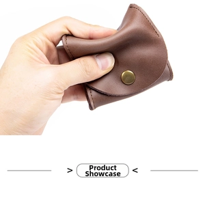 Close-up showing the soft texture and brass button of the brown leather coin pouch