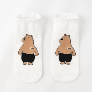 Detail of white cotton ankle sock featuring a cute cartoon bear pattern and bebe label