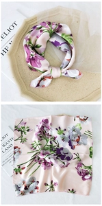 Detail showing elegant floral print silk scarf with fine rolled edges and pink floral patterns