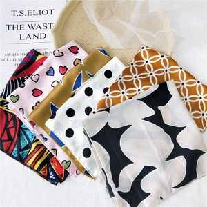 Collection of silky satin square scarves with diverse patterns and vibrant prints
