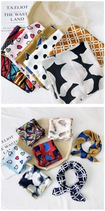 Detailed close-up showing silky texture and fine hemmed edges of printed silk scarves