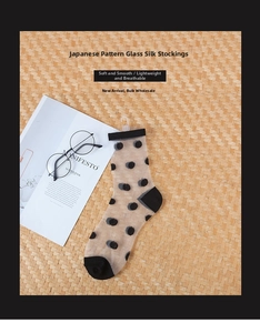Japanese style sheer glass socks with black polka dots on transparent mesh material