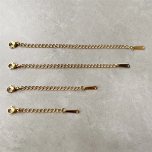 Detailed view of four lengths of golden stainless steel jewelry extension chains with clasps