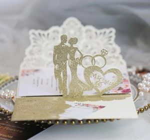 Detailed laser-cut wedding invitation with gold glitter Mr & Mrs silhouette and rings
