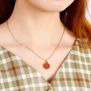 Golden necklace with a red rose flower pendant on a model's neck for elegant daily wear