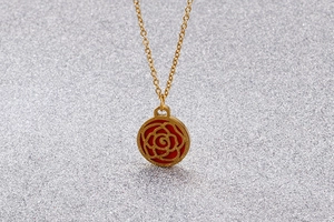 Close-up of golden necklace with hollow rose flower pendant on a sparkling background