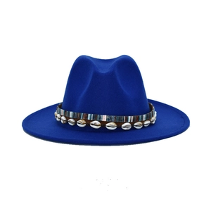 Detail of royal blue wool fedora featuring ethnic woven band and white seashell ornaments