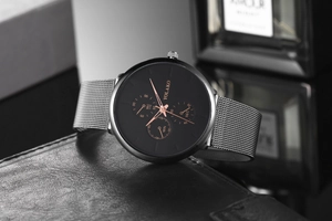 Detail of Yolako men's watch with blue hands and silver mesh strap on black leather