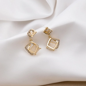 Geometric gold-tone drop earrings with sparkling rhinestones and square cat-eye stones