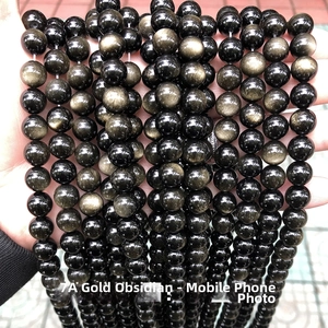 Close-up of 7A grade natural golden obsidian beads with authentic gold sheen effect