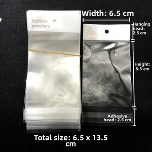 Detailed view of clear OPP jewelry bag showing 6.5x13.5cm dimensions and white header