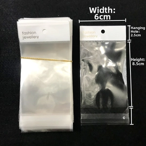 Detail view of 6x14cm transparent OPP jewelry bag showing dimensions and white header card