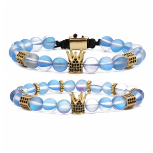 Beaded bracelet set with blue agate and golden crown charms on a clean white background