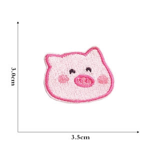 Macro detail of pink pig embroidery patch showing precise 3.5cm by 3.0cm dimensions