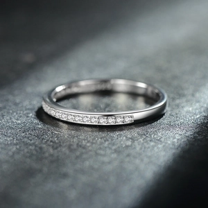 Minimalist S925 sterling silver ring with micro-pave diamond row on dark surface
