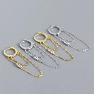 Detail of silver and gold tassel drop earrings with sparkling crystal accents
