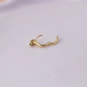 Golden snake-shaped copper earring with sparkling zircon inlays in a trendy punk style