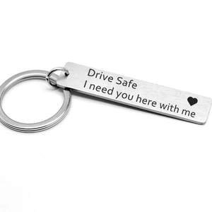 Close-up of engraved Drive Safe message and heart on silver stainless steel keychain