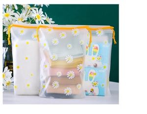 Detail of frosted daisy drawstring bags for socks and tissues with yellow cords