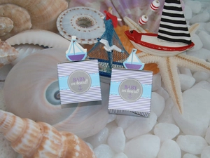 Blue and white nautical baby shower gift box with sailboat topper and BABY ON BOARD text