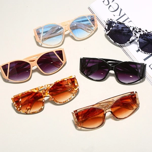 Close-up of oversized cat-eye sunglasses in multiple colors on a stylish magazine