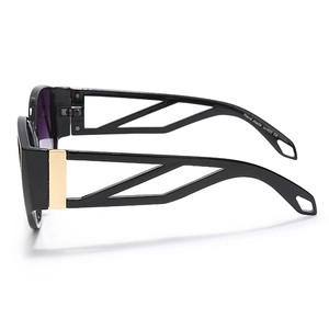 Side view detail of black cat-eye sunglasses with golden metal hinges and glossy finish