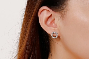 Close-up of silver-tone crystal pavé hoop earring worn by a model for daily style