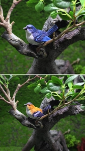 Detailed view of lifelike resin bird figurines with textured feathers on mossy branches