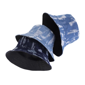 Distressed denim bucket hats in navy, medium, and light blue with frayed edge details