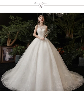 Exquisite white lace embroidery and shimmering glitter detail on long wedding dress train