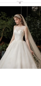 Detail of white lace embroidery and sheer neckline on a bohemian bridal gown