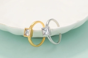 Adjustable copper rings with square cubic zirconia in gold and silver finishes